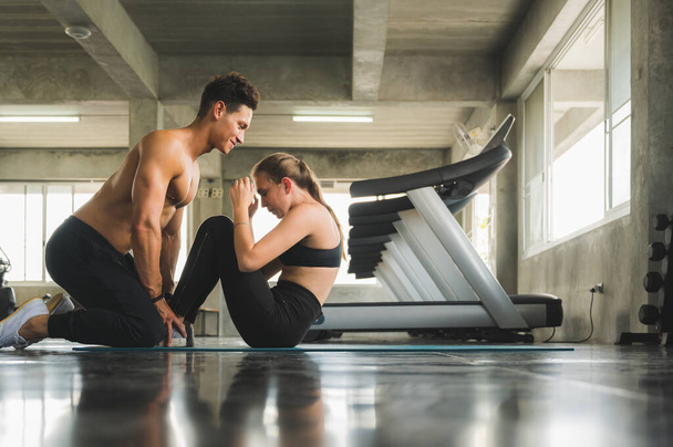 Couple love young fitness man and women workout exercise together. Weight training and cardio program concept. - Photo, Image