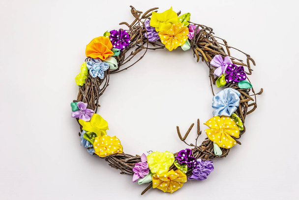Wreath of birch branches and craft colorful flowers isolated on white background. Spring composition, Easter decor. Handmade from satin polka dot ribbons, stay home concept - Fotografie, Obrázek