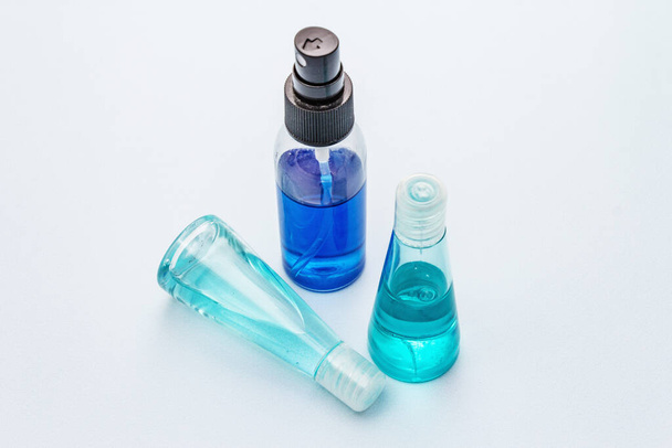 Sanitizer spray and gel isolated on blue background. Medical products for personal hygiene and the prevention of viral diseases. Coronavirus, COVID-19 pandemic, 2019-nCoV worldwide concept - Photo, Image
