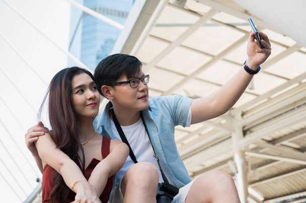 Couple love man and woman using smartphone to take a selfie. - Photo, Image