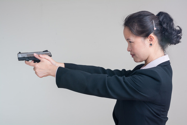 Woman aiming a hand gun - Photo, Image