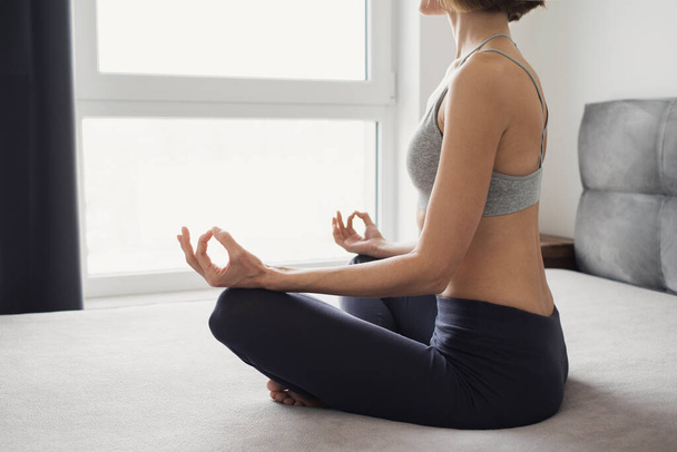 young woman practicing yoga at home  - Фото, зображення
