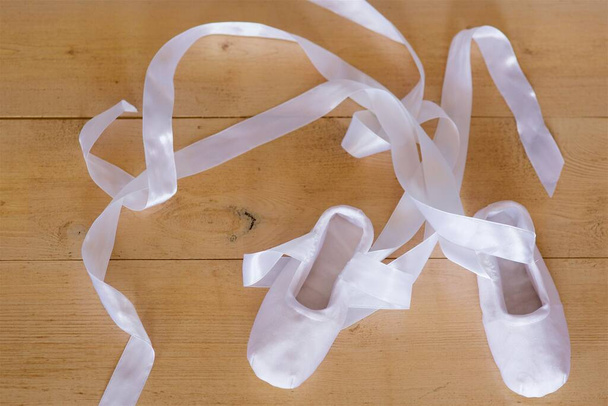 White ballet Slippers for dancing. The size of a little girl. - Φωτογραφία, εικόνα