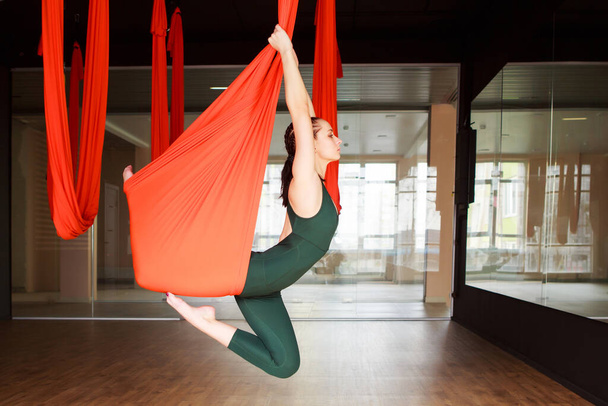 Woman aerostretching, aerial yoga therapy. - Foto, Bild