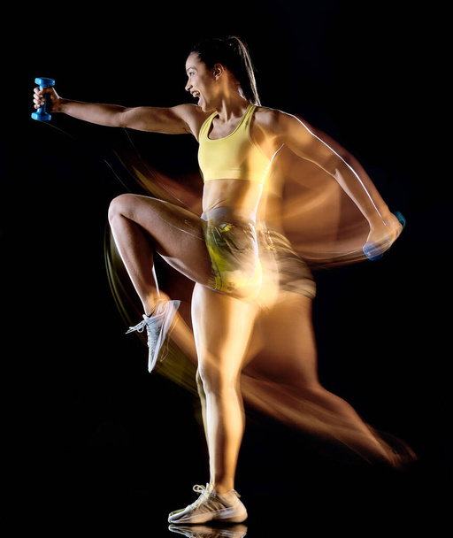 woman exercising fitness exercises isolated black background lightpainting effect - Фото, изображение