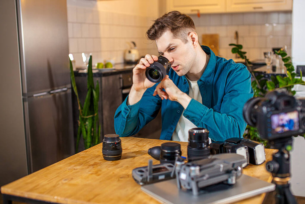 blogger studying his new cameras - 写真・画像