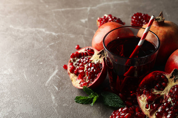 Pomegranate and juice on brown table, close up - Photo, Image