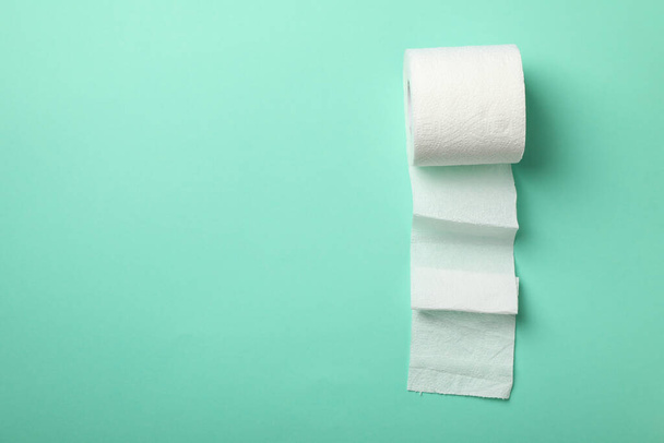 Toilet paper on mint background, space for text - Photo, Image