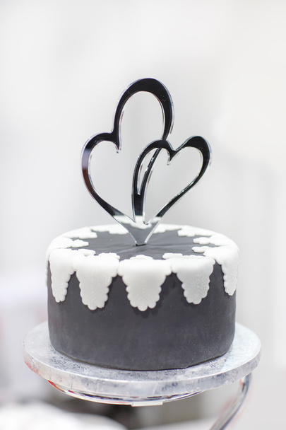 Wedding cake in black and white with heart decoration. - Foto, Imagen