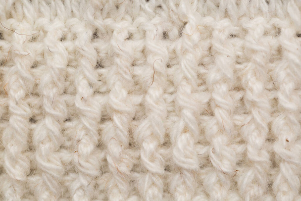 knitted fabric background texture is white. Ornament. - Фото, изображение