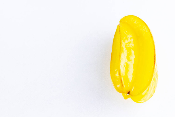 Carambola on the white background. Star Fruit (Averrhoa carambola L.) with copy space. Yellow fruit carambola. Top view - Фото, изображение
