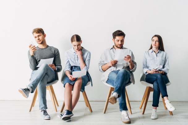 Group of young people with resume waiting for job interview in office  - Photo, Image