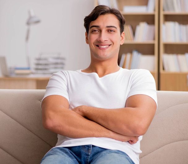 Young man relaxing sitting in couch sofa - Foto, Imagem