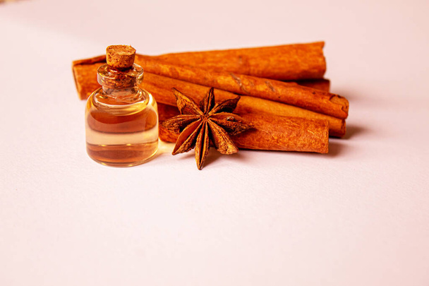 Cinnamon essential oil in a small bottle.Star anise oil in a small bottle. Selective focus. - Photo, Image