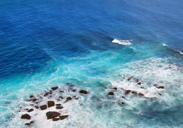 Aerial view of sea waves and fantastic Rocky coast. Photo in rich blue tones. - Foto, Imagem