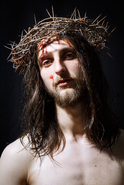 Jesus Christ with long hair and crown of thorns, blood on forehead. - Fotó, kép