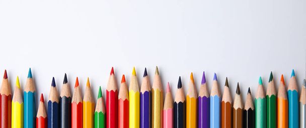 Цветные карандаши на белом фоне, вид сверху с пробелами для текста. Баннерный дизайн
 - Фото, изображение