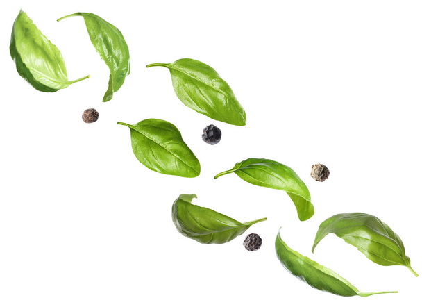 Basil leaves and black pepper on white background - Photo, Image