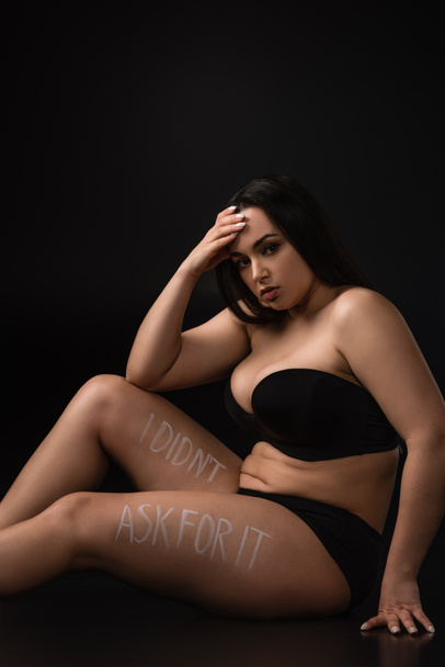 Upset plus size model with lettering I Did not Ask For It on body on black background - Photo, Image