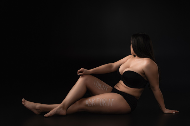 Full length plus size model in underwear with lettering  I Did not Ask For It on body on black background - Photo, Image