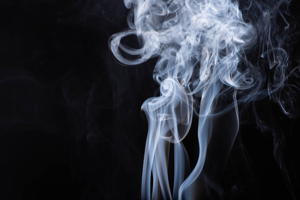 abstract white flowing smoke clouds on black background - Foto, imagen