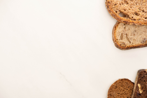 top view of fresh whole grain bread slices on white background with copy space - Valokuva, kuva
