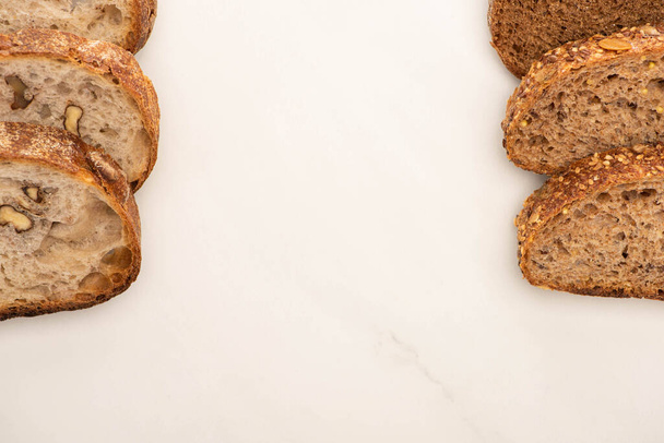 top view of fresh whole wheat bread slices on white background with copy space - Photo, Image