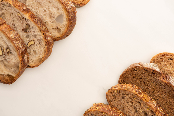 top view of whole wheat bread slices on white background with copy space - Foto, immagini