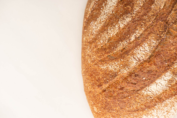 top view of fresh bread loaf on white background with copy space - Foto, Imagem