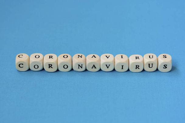 Text phrase Coronavirus made from wooden blocks, over blue background. Novel coronavirus 2019-nCoV. - Photo, image