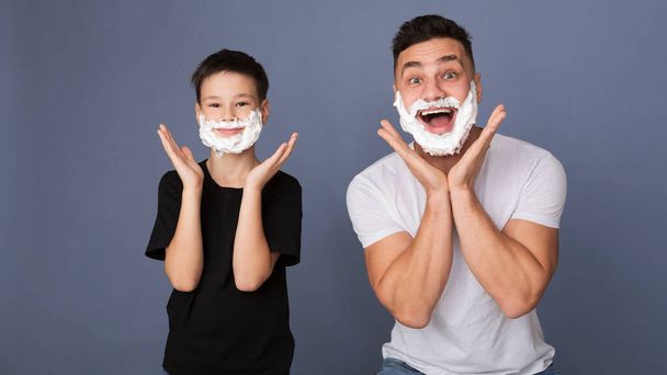 Dad teaching his son to shave, putting foam on face - Photo, Image