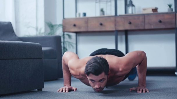 вид на поверхность молодой спортсмен делает отжимания на полу в домашних условиях
 - Кадры, видео