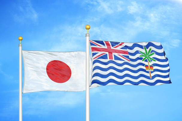 Japan and British Indian Territory two flags on flagpoles and blue cloudy sky background - Photo, Image