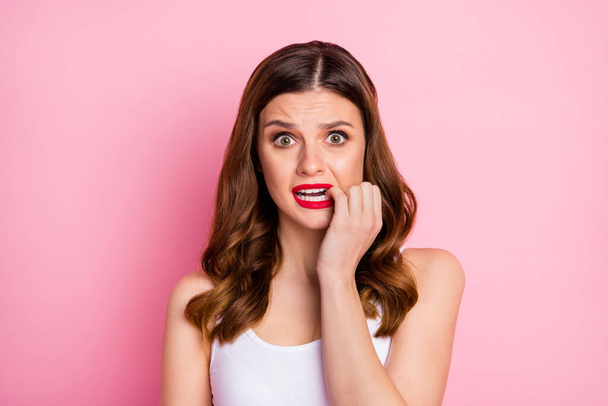 Portrait of frustrated anxious red head girl listen horrible mistake news impressed bite nails teeth feel fear wear beautiful singlet isolated over pink color background - Zdjęcie, obraz