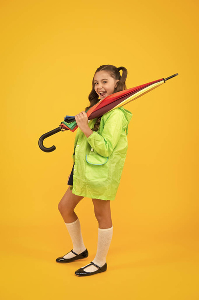 Autumn weather. Totally ready. Schoolgirl with umbrella wear waterproof raincoat. Autumn rain. Going to school. Water resistant clothes. Protected concept. Rainproof clothes. Autumn accessory - Foto, immagini