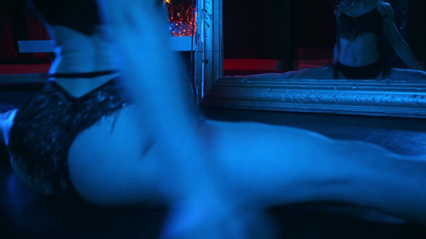 flexible stripper dancing near mirror in strip club  - Footage, Video