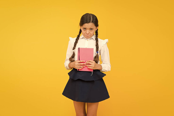 Practice and improve reading skills for school studies. Back to school concept. Girl hold book. School girl on yellow background. Study language. Study at home. Cute child study with textbook - Photo, image