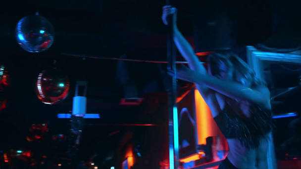 sexy woman in heels dancing near pylon in strip club  - Filmati, video