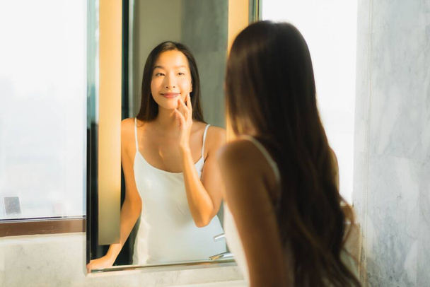 Güzel bir Asyalı kadın portresi. Banyo içinde yüzünü ve yüzünü kontrol et. - Fotoğraf, Görsel