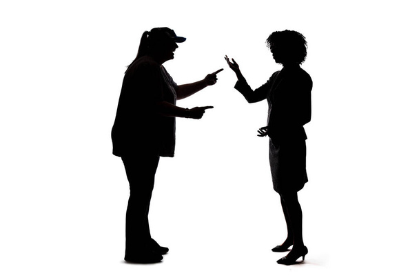 Silhouette of people talking to each other, socializing and not practicing social distancing.  They are on a white background and meeting or sharing gossip - Photo, Image