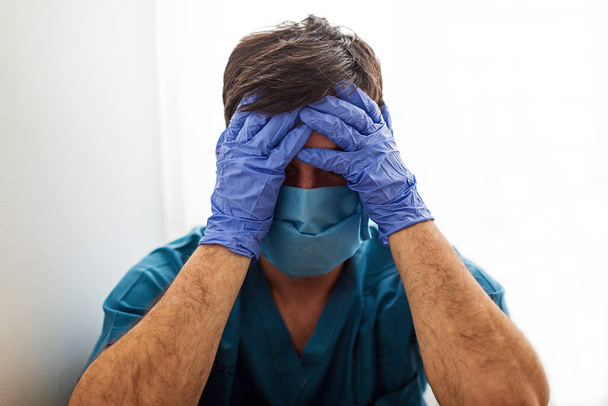Upset and Disappointed Doctor Cover His Face With Hands In a Desperate Gestures - Fotoğraf, Görsel