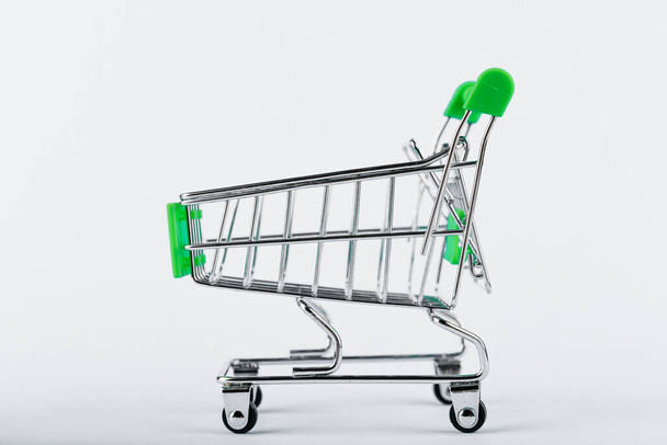 Shopping trolley on a white background. Green color. Place for an inscription. Shopping concept - Фото, зображення