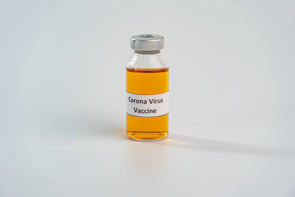 COVID-19 vaccine in medical bottle on white background  - Foto, Imagen
