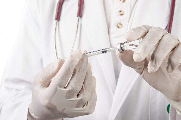 Injecting vaccination medicine on man doctor, medical concept. - Valokuva, kuva