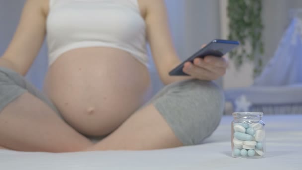 Pregnant woman looks for information and prescription online - Video, Çekim
