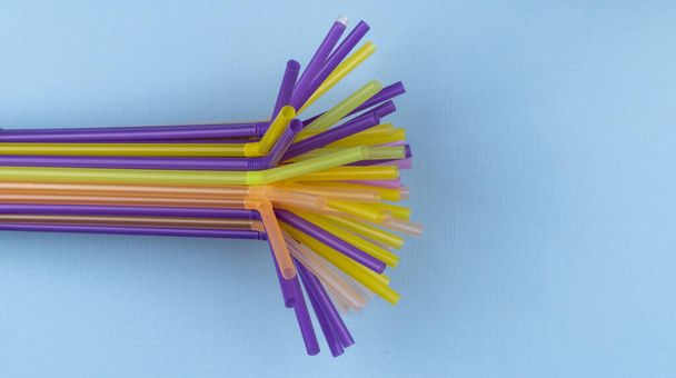 colorful straws for summer cocktails on light blue background with copy space. Top view. Drinking Straw Day, January 3. - Photo, Image