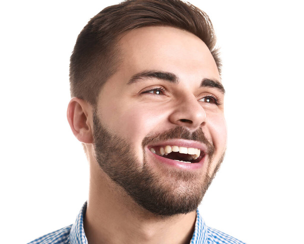 schöner lächelnder junger Mann auf weißem Hintergrund - Foto, Bild