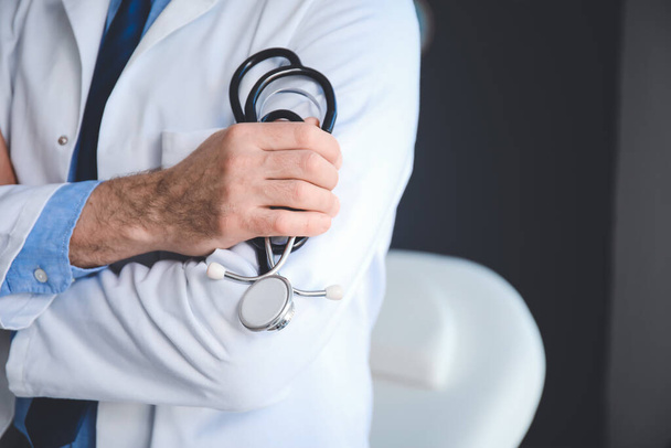 Senior male doctor with stethoscope in clinic, closeup - Photo, Image