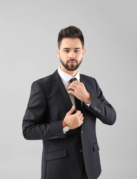Handsome businessman with healthy hair on light background - Photo, Image