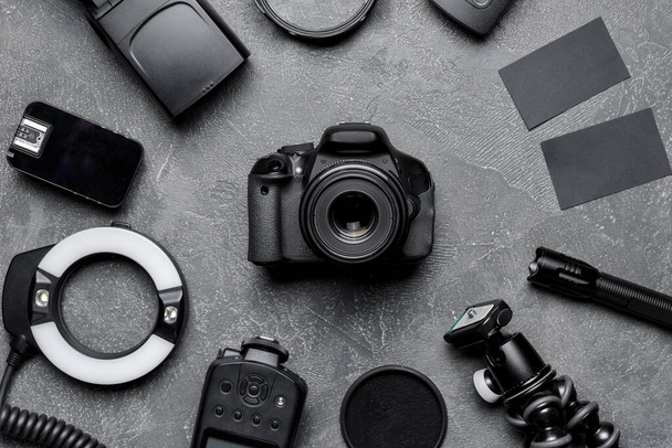 Modern photographer's equipment with cards on dark background - Φωτογραφία, εικόνα